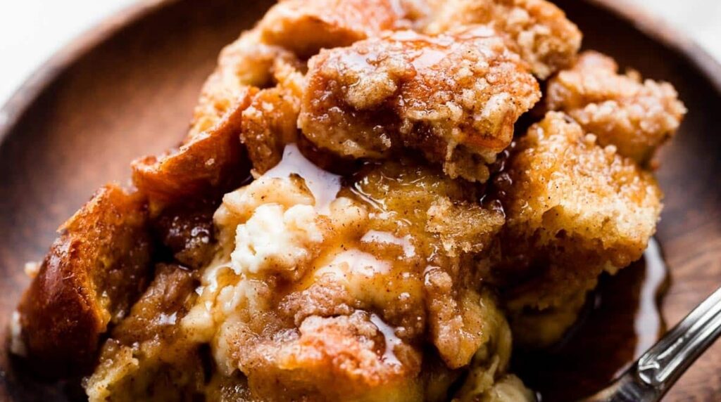 Ultra close-up macro of bubbling golden brown cinnamon streusel french toast bake with melted butter and pure maple syrup