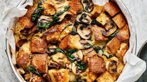 Ultra close-up macro of golden bubbling spinach mushroom breakfast strata fresh from the oven in a baking pan
